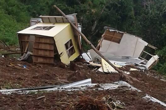 Damaged houses are seen after a landslide.