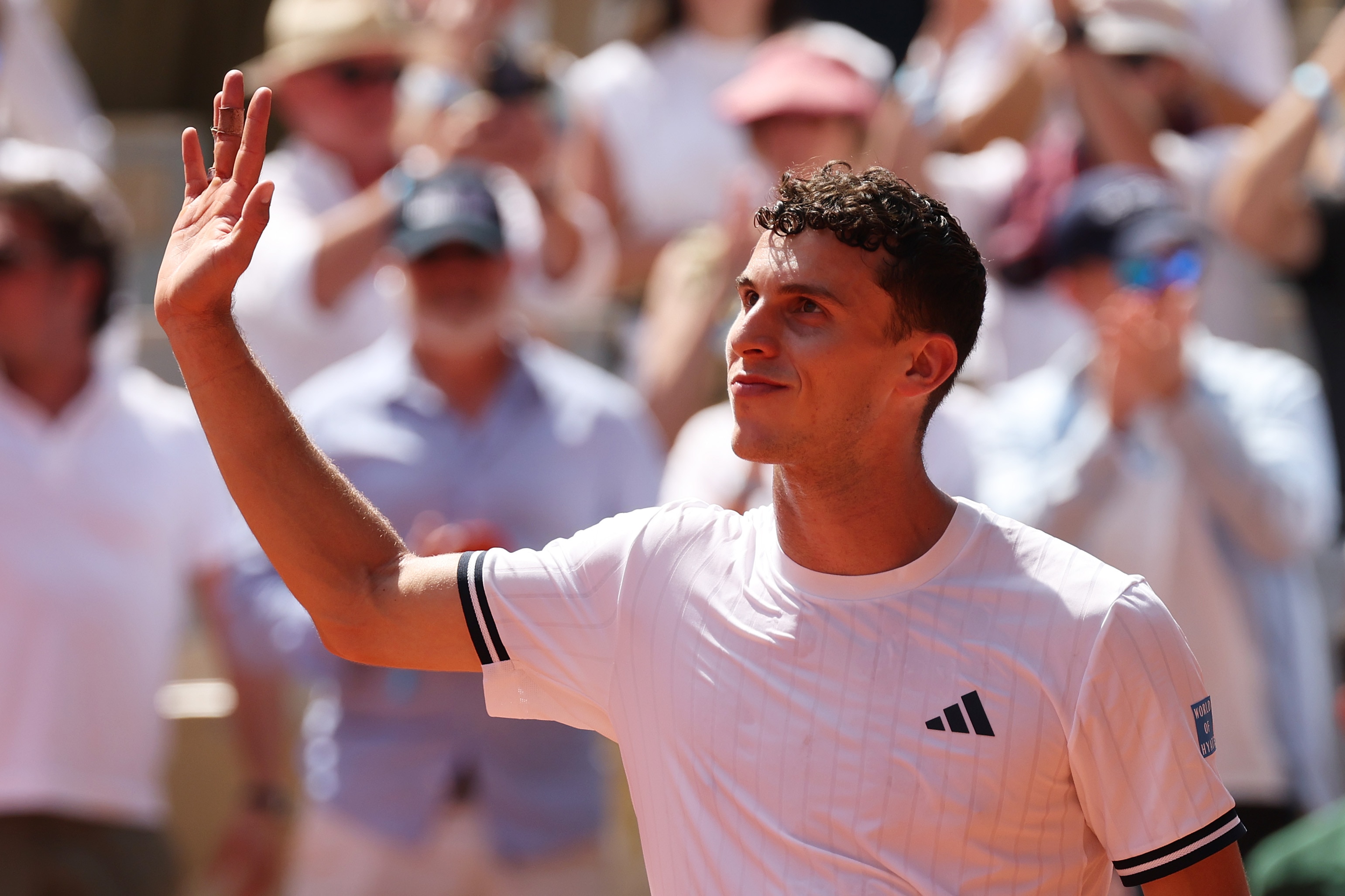Juan Manuel Cerundolo waves to the French Open crowd.