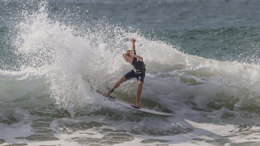 A boy surfing