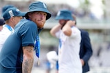 Ben Stokes sits and looks over his shoulder