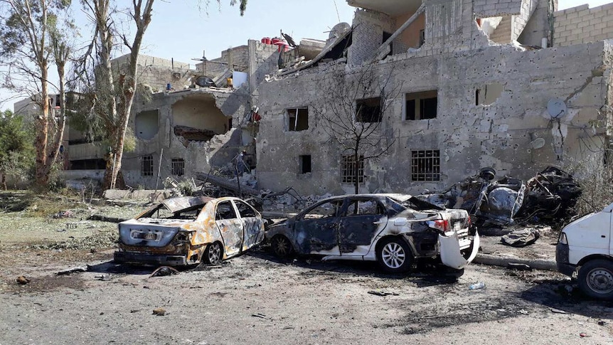 Several cars damaged in the car bomb attack along the road to the airport in southeast Damascus.