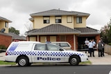 Police investigate at the home where Herman Rockerfeller's alleged murderers were arrested.