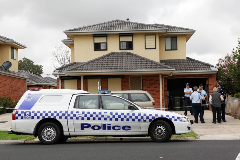 Police investigate at the home where Herman Rockerfeller's alleged murderers were arrested.