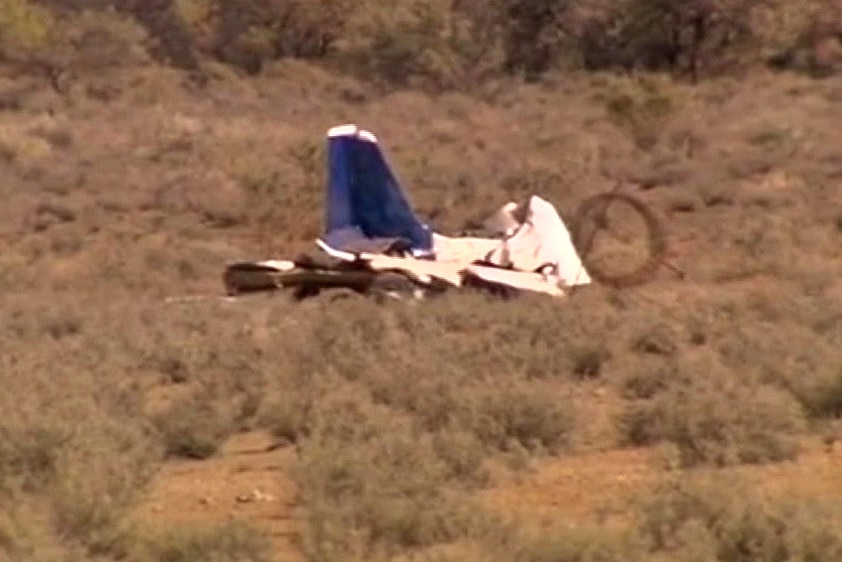 The wreckage of a Brumby 610 light plane surrounded by scrub.