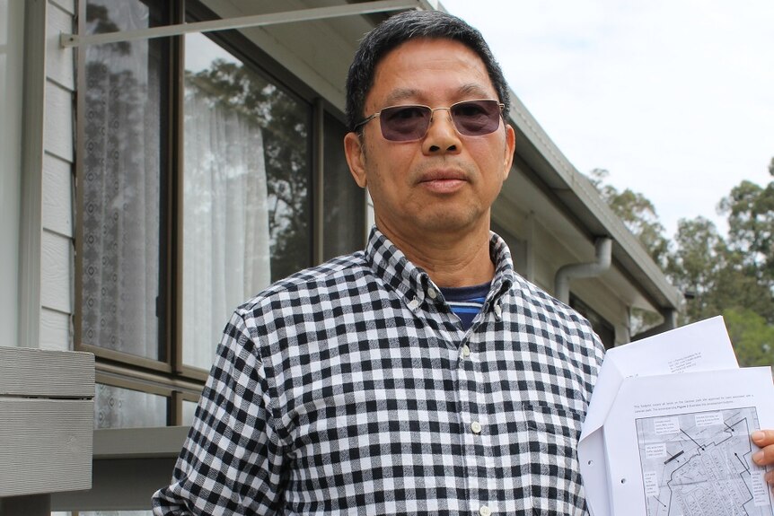 Property developer William Hu shows his approval to expand the Woombah Woods Caravan Park - Aug 2019.