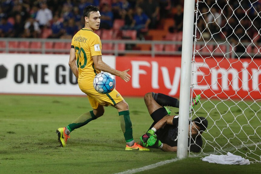 Thailand keeper Kawin Thamsatchanan saves from Australia's Trent Sainsbury in World Cup qualifier.