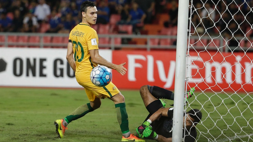 Thailand's Kawin Thamsatchanan saves from Australia's Trent Sainsbury in World Cup qualifier.