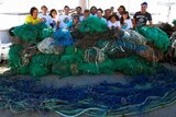 Members of the Ocean Cleanup crew with a monster ghost net