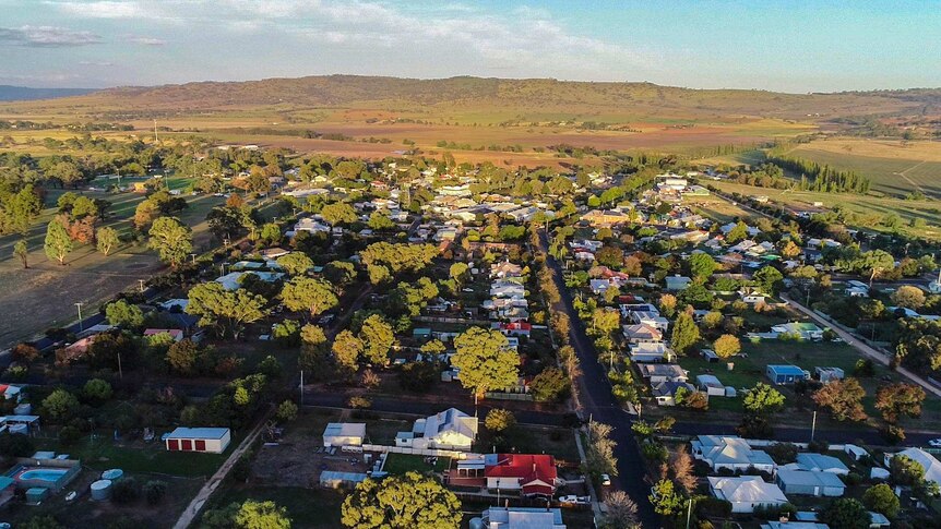 Aerial view of small regional NSW town of Coolah with green tinged hills in the distance