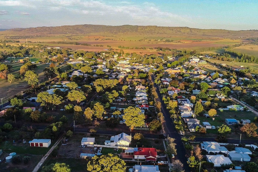 Aerial view of small regional NSW town of Coolah with green tinged hills in the distance
