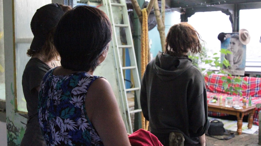 Image of three women looking out from a backyard in Sydney.