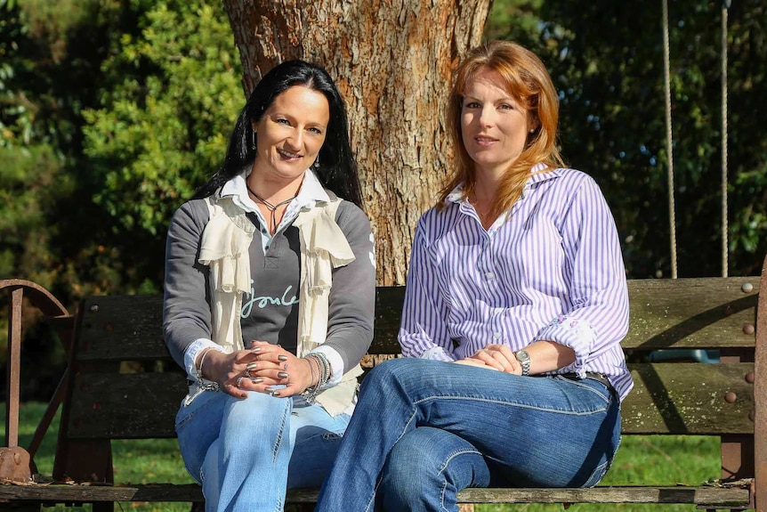 Zoe Ednie-Brown and Jahna Trethowan sitting on a bench.