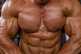 a ripped bodybuilder flexes his chest