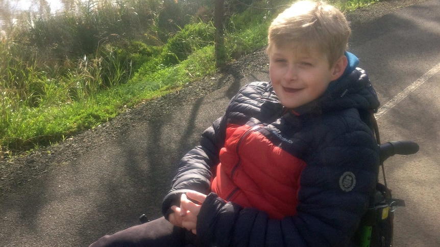 smiling boy in wheelchair