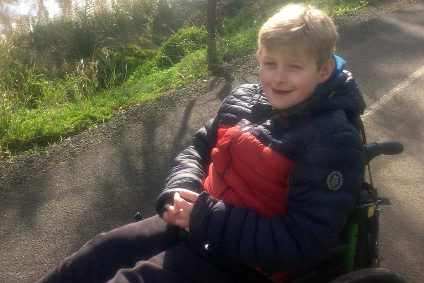 smiling boy in wheelchair