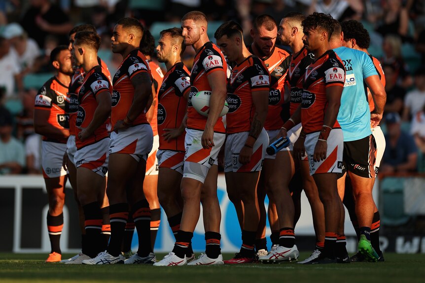 Wests Tigers NRL players group together as they wait for a conversion attempt against Gold Coast.