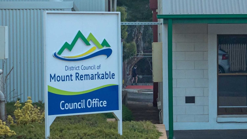 A small tin roofed building with the name District Council of Mount Remarkable on it, surrounded by trees.