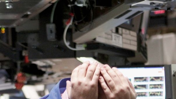 A trader shows the strain on the floor of the New York Stock Exchange