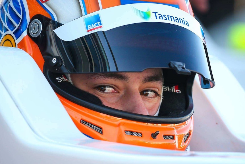 Close up of Tasmanian race car driver Alex Peroni in helmet.