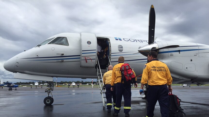 A group gets on board a small plane.