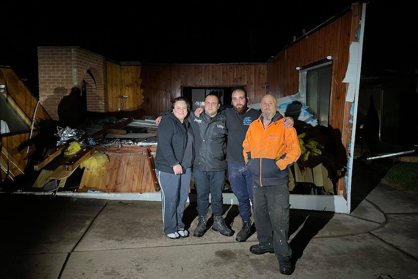 Morris Saba with his family after tornado destroyed house behind 