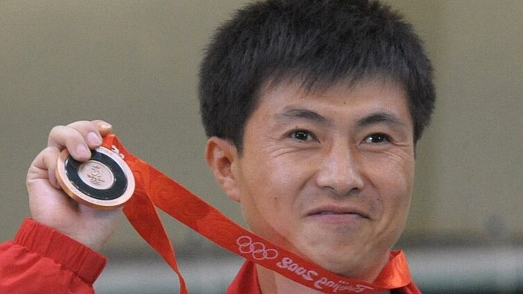 Kim Jong Su holds his bronze medal
