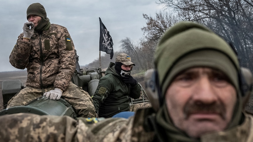 Three Ukrainian servicemen seen riding a 2S7 Pion self-propelled gun.