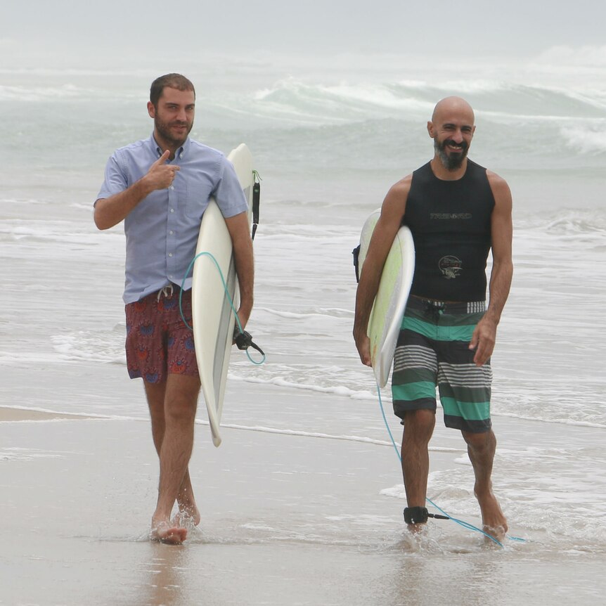 Hadi Beydoun and Paul Abbas watch the surf in Assinie