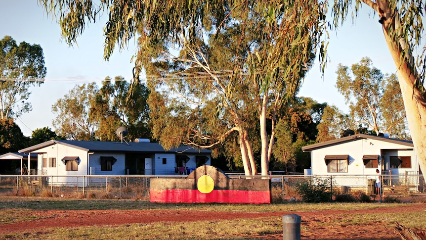 A plaque representing an Aboriginal flag in a community park