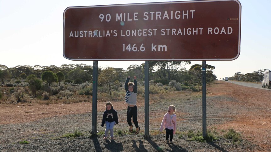 Vanessa Steel's children in front of a road sign.