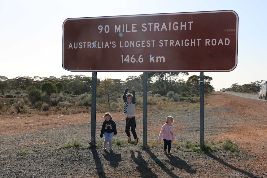 Vanessa Steel's children in front of a road sign.