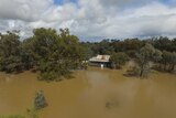 A drone image of a homestead surrounded by deep floodwater