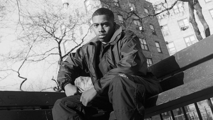 New York rapper Nas sits on a park bench in the Queensbridge Houses project