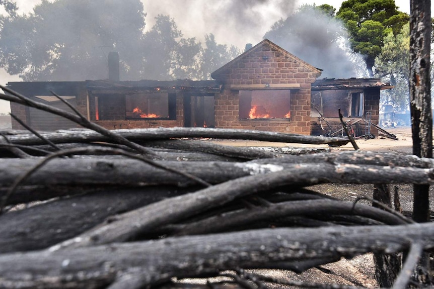 Fire burns a house