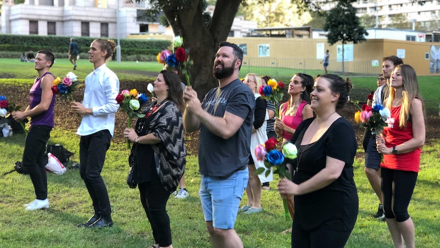 A group of people dancing in a Sydney park.