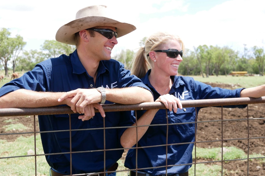 Jade and Blair on their dairy property at Cooranga North, one of the sites of AGL’s Coopers Gap windfarm.