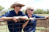 Jade and Blair on their dairy property at Cooranga North, one of the sites of AGL’s Coopers Gap windfarm.