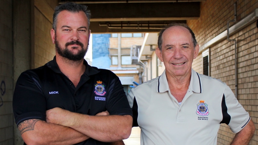Mick Lay and Neil Wex stand in a Bundaberg alley. The men will compete in a 100km trail walk for charity.