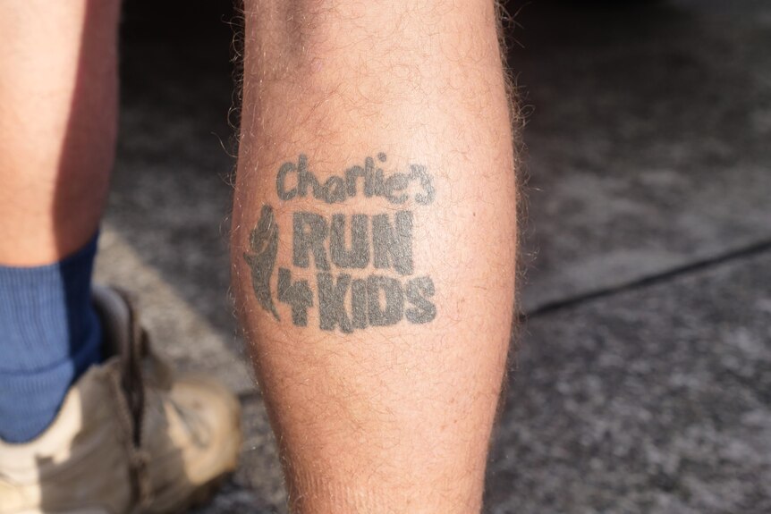 A tattoo on the back of Cheyne Waddingham's leg that says Charlies Run 4 Kids