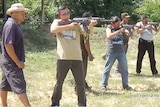 A photo of men fire AK-47s at the Cambodia Firing Range Outdoor Phnom Penh, since removed from the firing range's website.