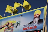 A man on a poster wearing a turban.