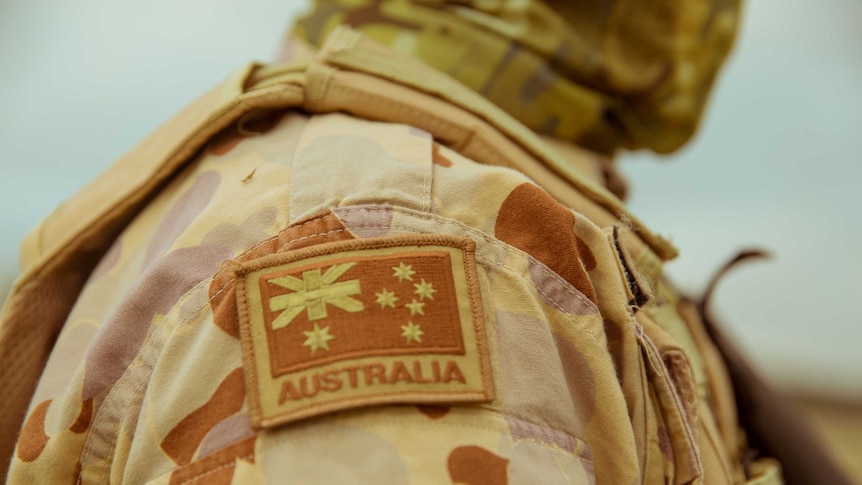 The Australian flag sowed onto the arm of a military uniform worn by a man