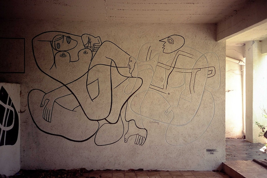 An interior mural originally drawn by Le Corbusier as it is being restored, with only half being outlined