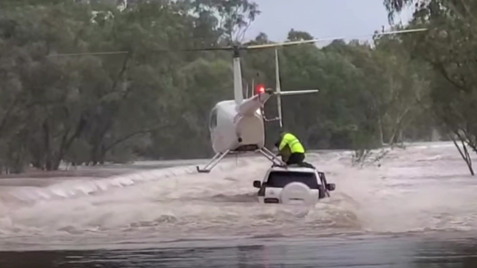 Chopper rescues pair and dog from croc-inhabited floodwaters in Katherine