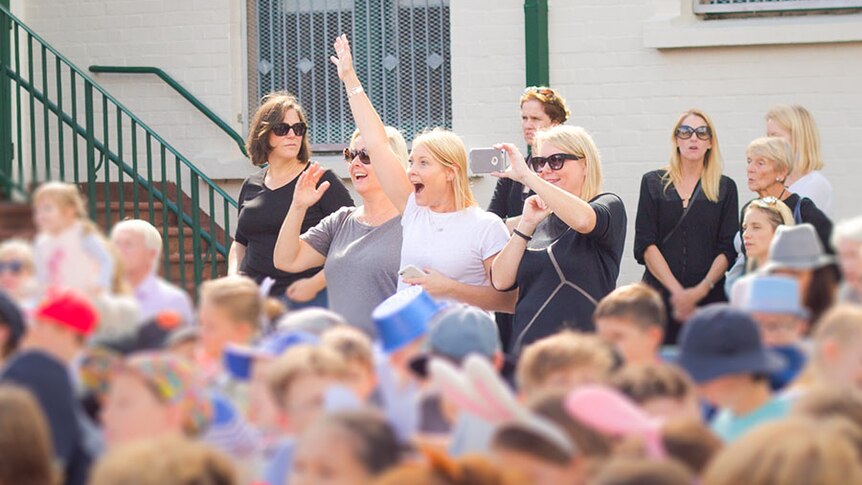 Kids at school with parents watching