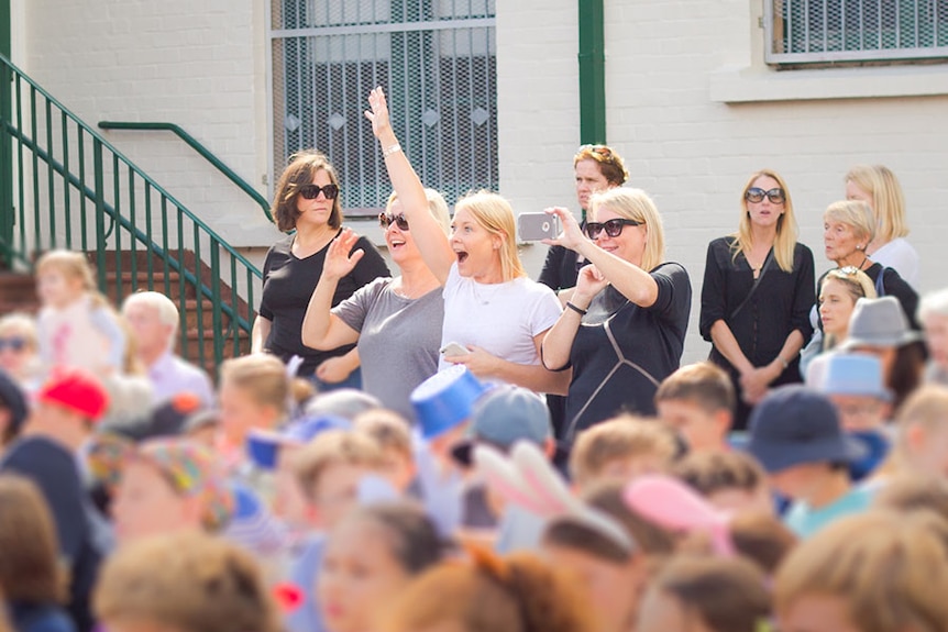 Kids at school with parents watching