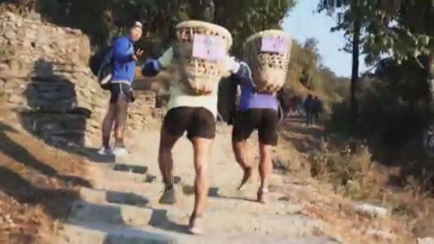 Young Nepalese men compete in the doko race for a coveted spot in the British Gurkha Army.