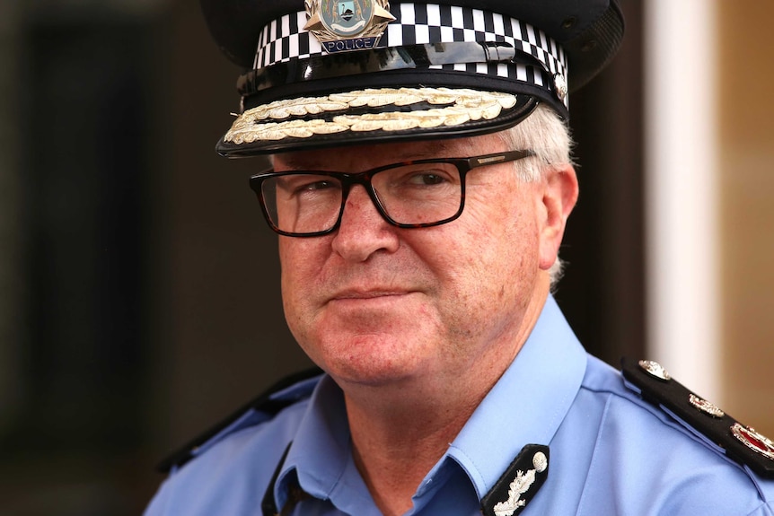 Chris Dawson speaks at a media conference outside parliament in WA wearing his uniform and his hat.