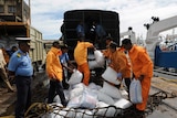 Indian relief workers load supplies