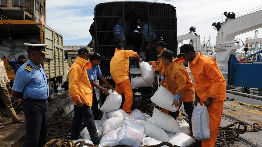 Indian relief workers load supplies